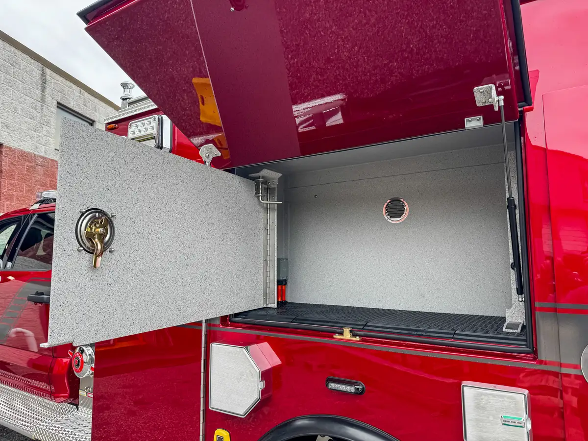 Rear corner compartment interior close-up with divider and side wiring.